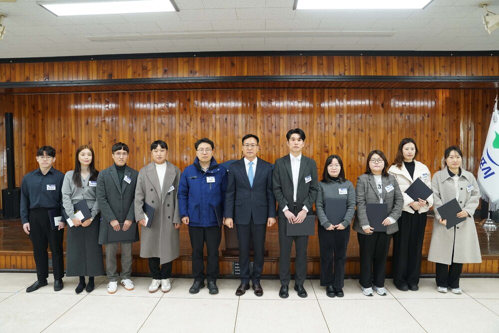 2월 정례조회 행사에서 정장을 입고 안경을 쓴 남성이 수상자들과 함께 기념촬영을 하고 있으며, 왼쪽부터 현승아, 노아형, 강보경, 홍지수, 권재혁, 김남우, 최성관, 이동준, 은미경, 정지수가 상장을 들고 일렬로 서 있다.